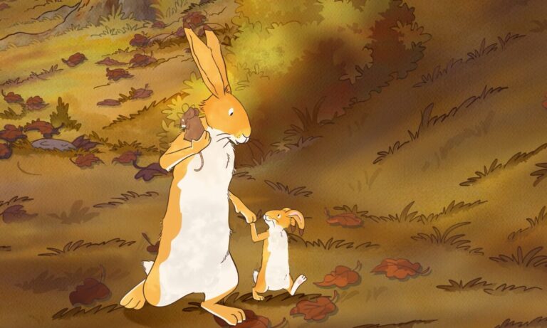 A large, brown and white rabbit sits on a forest floor covered with leaves, tenderly holding a smaller rabbit. Trees and bushes with autumn foliage are in the background. Both rabbits appear content.